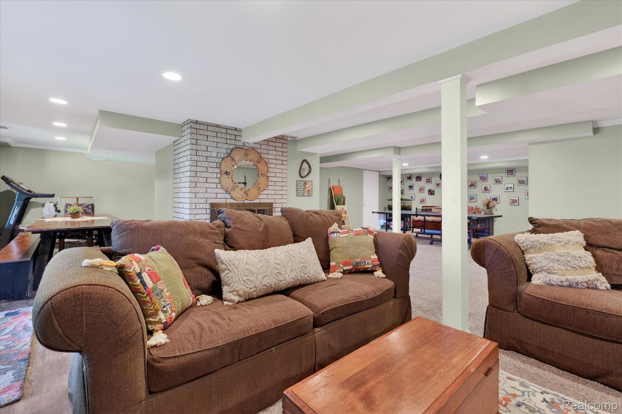 3860 East Commerce Road Commerce Township, MI 48382 - Photo 41 of 72 Spacious lower level featuring a white brick fireplace, recessed lighting, carpet flooring, and a light green wall finish