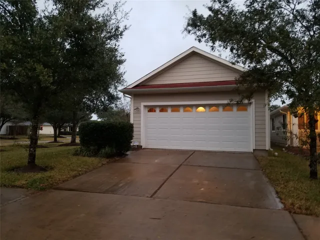 a front view of a house with a yard and tree
