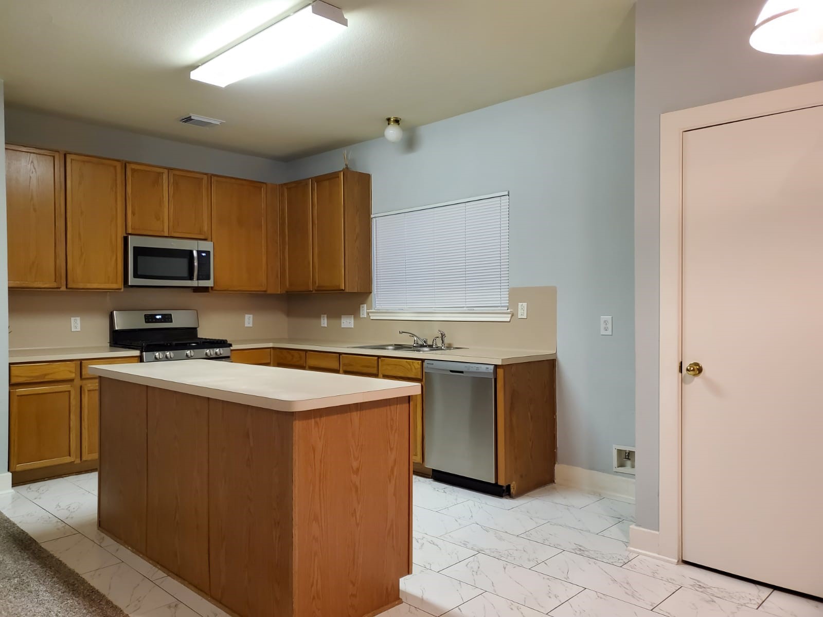 5722 Sonoma Ridge Missouri City, TX 77459 - Photo 6 of 12 a kitchen with stainless steel appliances granite countertop a stove a sink and a refrigerator