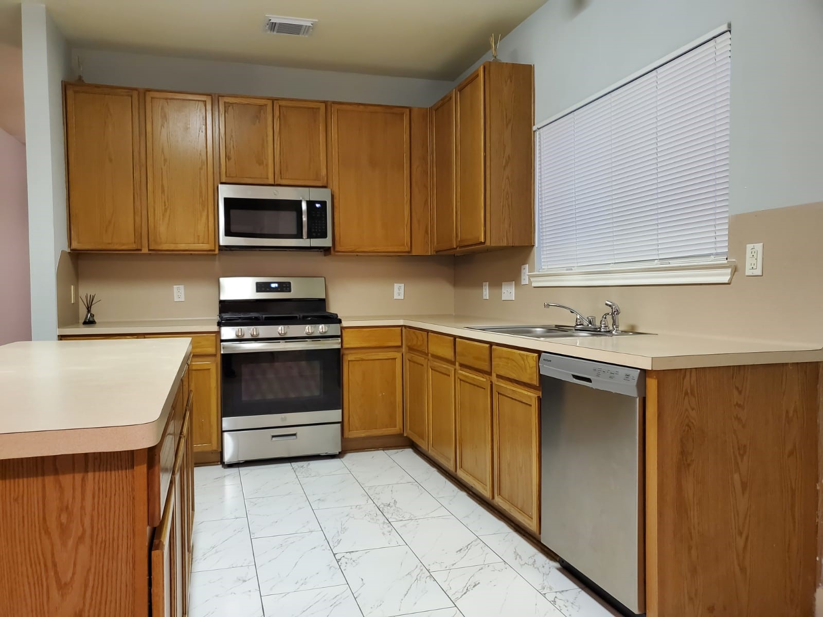 5722 Sonoma Ridge Missouri City, TX 77459 - Photo 7 of 12 a kitchen with granite countertop a sink a stove top oven and cabinetry