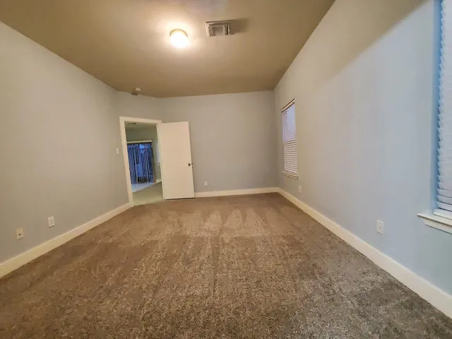 an empty room with a empty space and windows