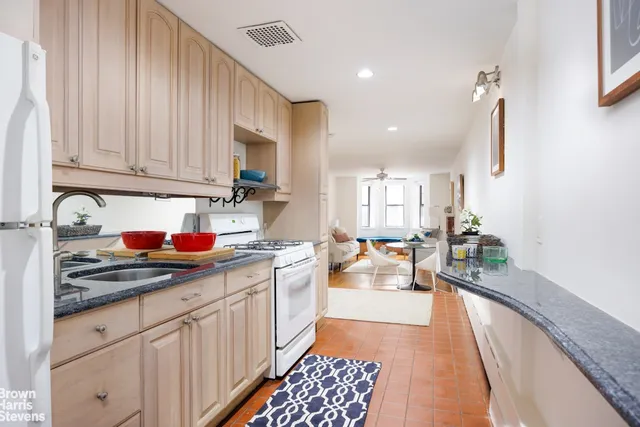 a kitchen with sink refrigerator and cabinets