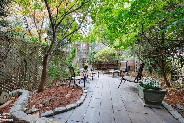 a view of a backyard with sitting area