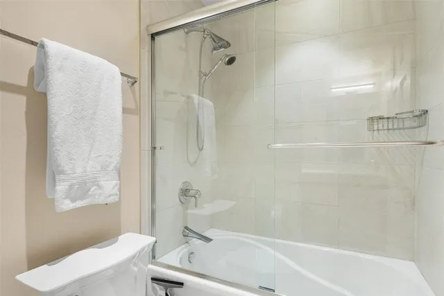 a bathroom with a shower and a toilet