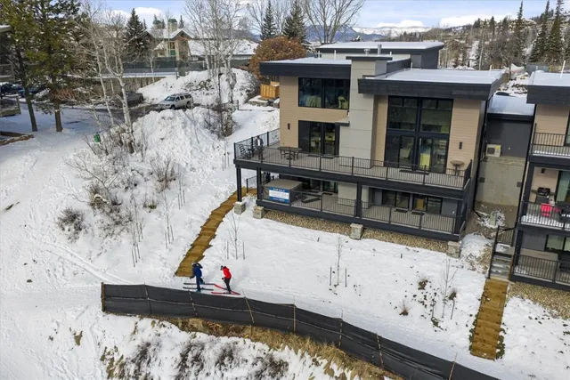 a view of house with wooden deck and furniture