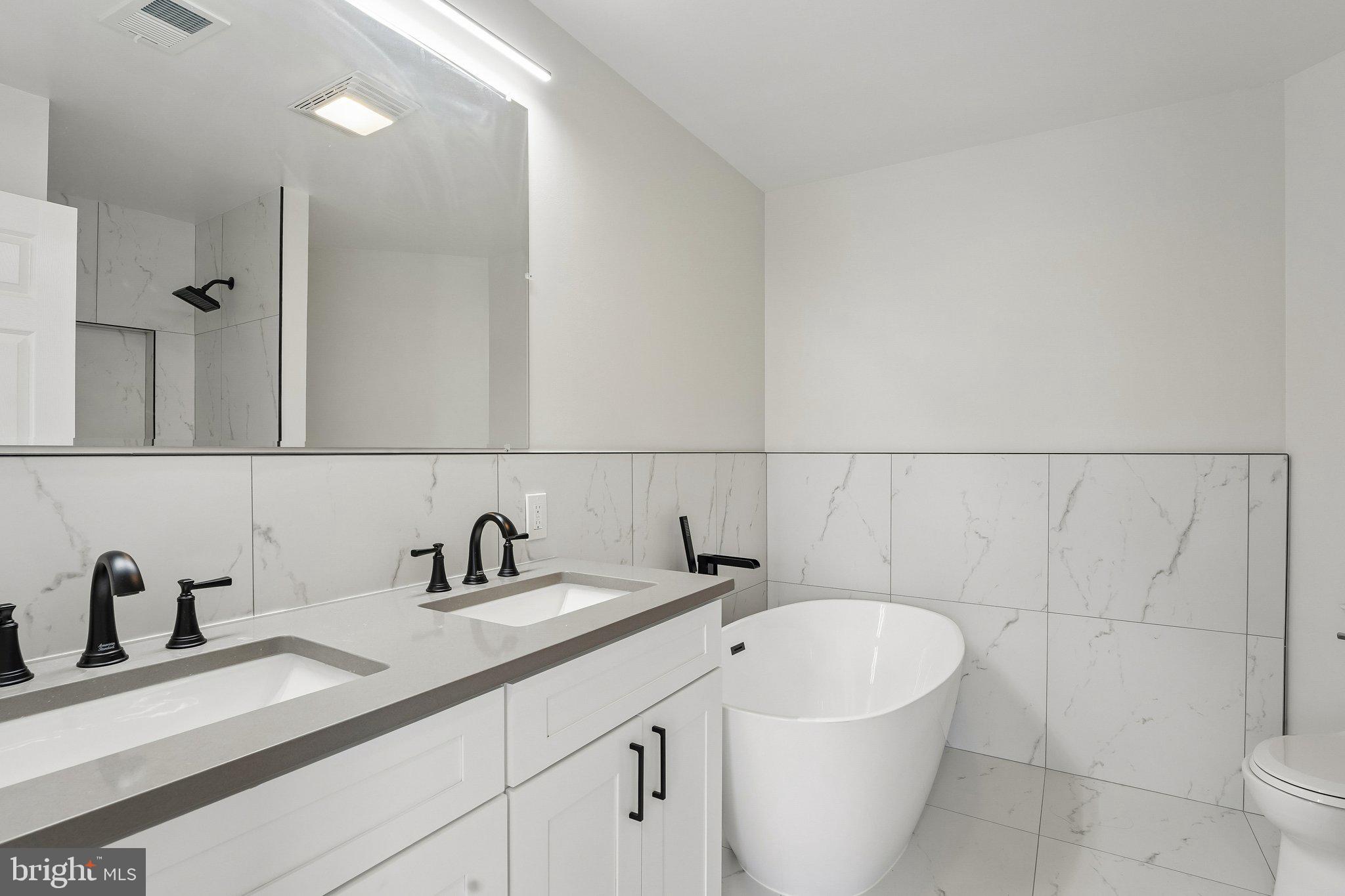 1992 Retta Gilliam Court Southeast Washington, DC 20020 - Photo 16 of 22 a bathroom with a sink and a mirror