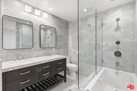 a bathroom with a granite countertop sink mirror and double