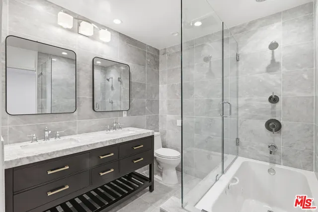 a bathroom with a granite countertop sink mirror and double