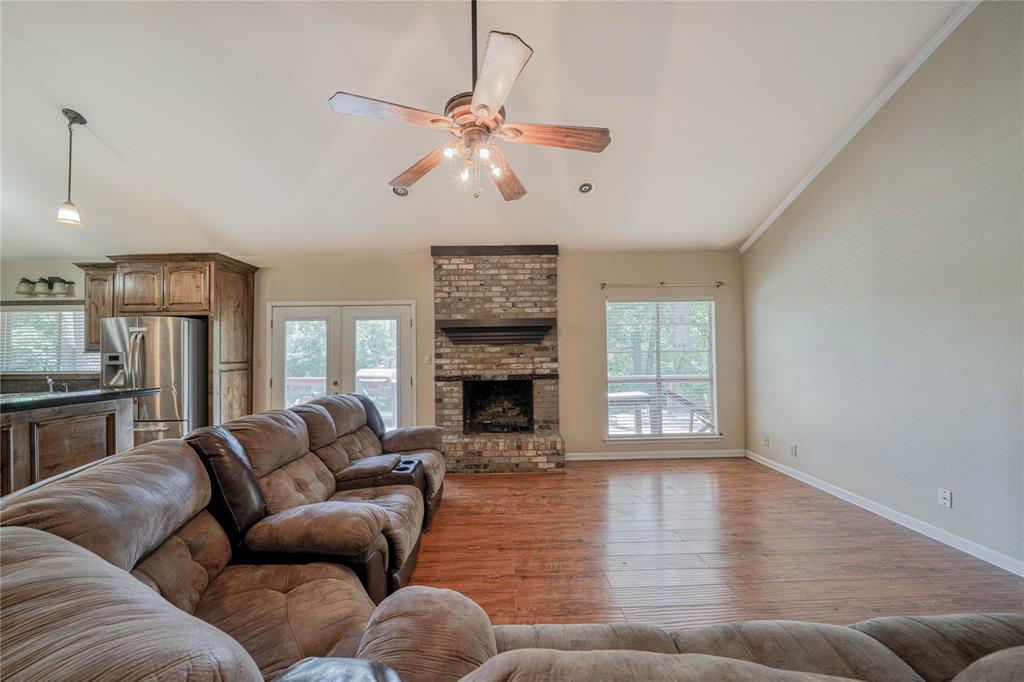 1006 Rikkity Lane Mount Pleasant, TX 75455 - Photo 9 of 39 a living room with furniture wooden floor and a fireplace
