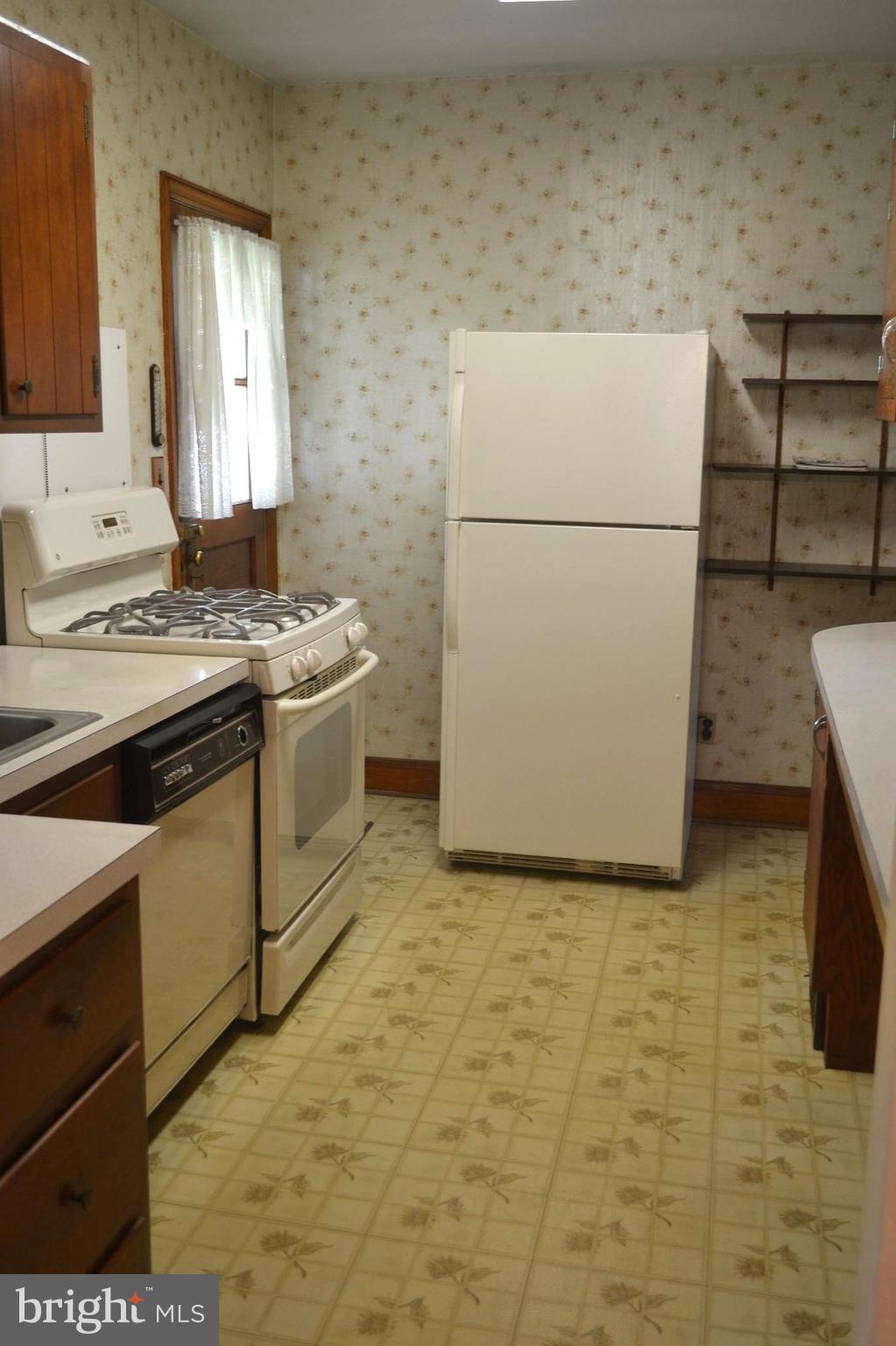 432 Cleveland Road Linthicum Heights, MD 21090 - Photo 4 of 18 a kitchen with a stove top oven and a refrigerator