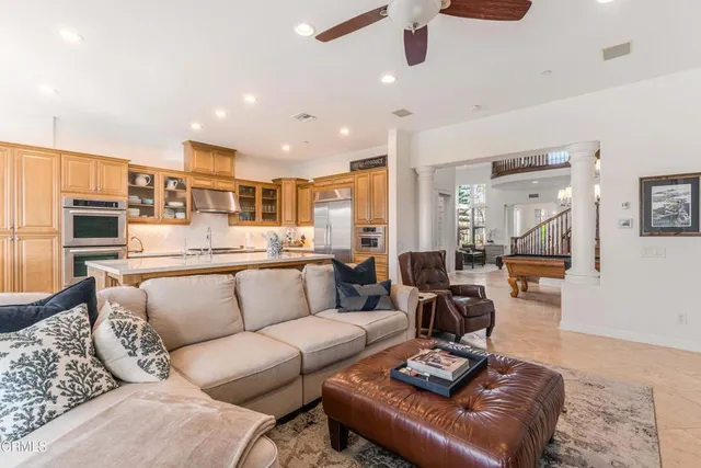 a kitchen with stainless steel appliances granite countertop a sink and a refrigerator
