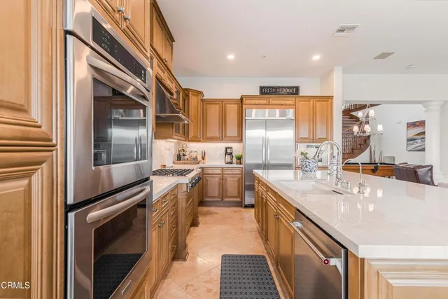 a kitchen with stainless steel appliances granite countertop a stove and cabinets