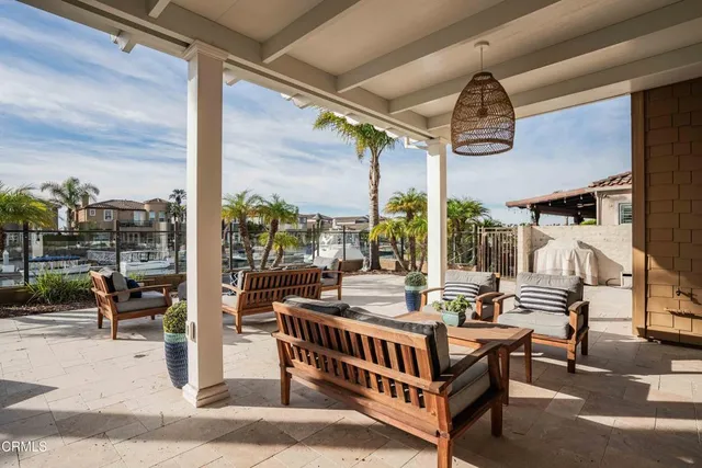 a row of palm trees and swimming pool in the backyard of a house