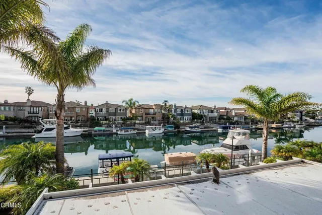 a kitchen with stainless steel appliances kitchen island granite countertop a refrigerator and a sink
