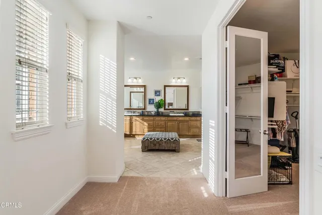 a spacious bathroom with a tub sink and mirror