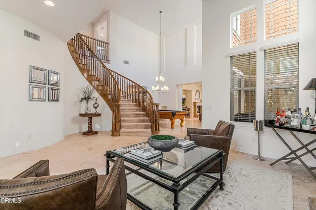 a room with pool table and windows
