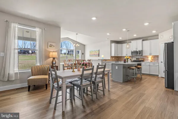 a kitchen with a sink a refrigerator a stove and cabinets