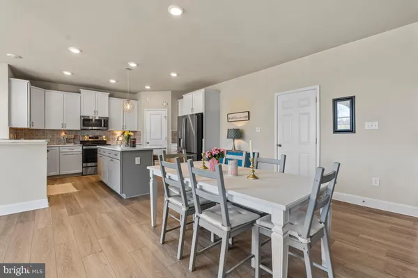 a kitchen with a sink cabinets and wooden floor
