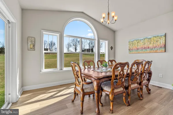 a kitchen with a refrigerator a sink cabinets and wooden floor