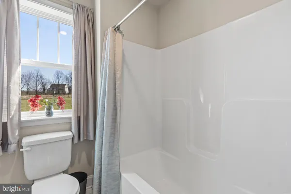 a en suite bathroom with a granite countertop sink and a mirror