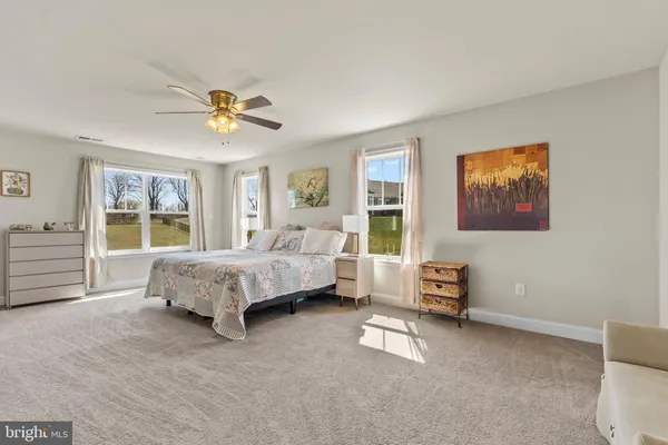 a view of a patio with table and chairs with wooden fence