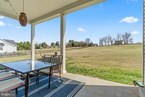 a view of swimming pool with a table and chairs