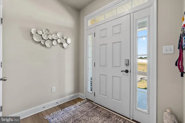 a living room with furniture a rug and a window