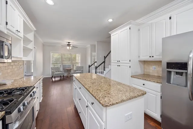 a kitchen with sink stove and cabinets