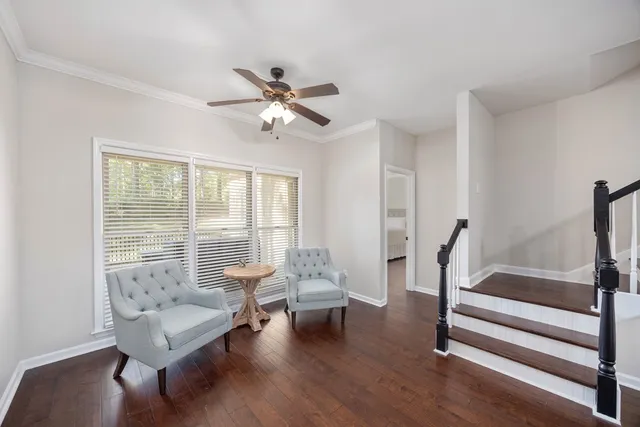 a living room with furniture and a floor to ceiling window