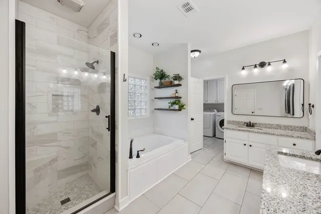 a bathroom with a tub sink and mirror