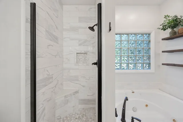 a bathroom with a bathtub and a shower