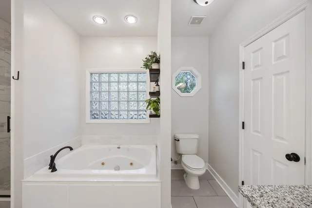 a bathroom with a toilet a sink and a bathtub