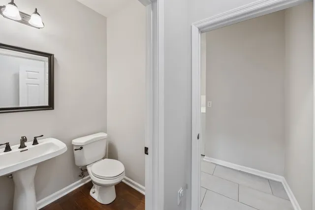 a white toilet sitting next to a bathroom sink