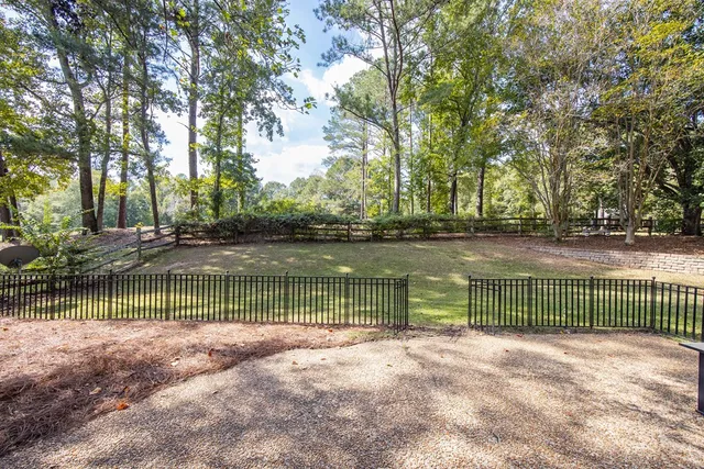 a view of park with trees in the background