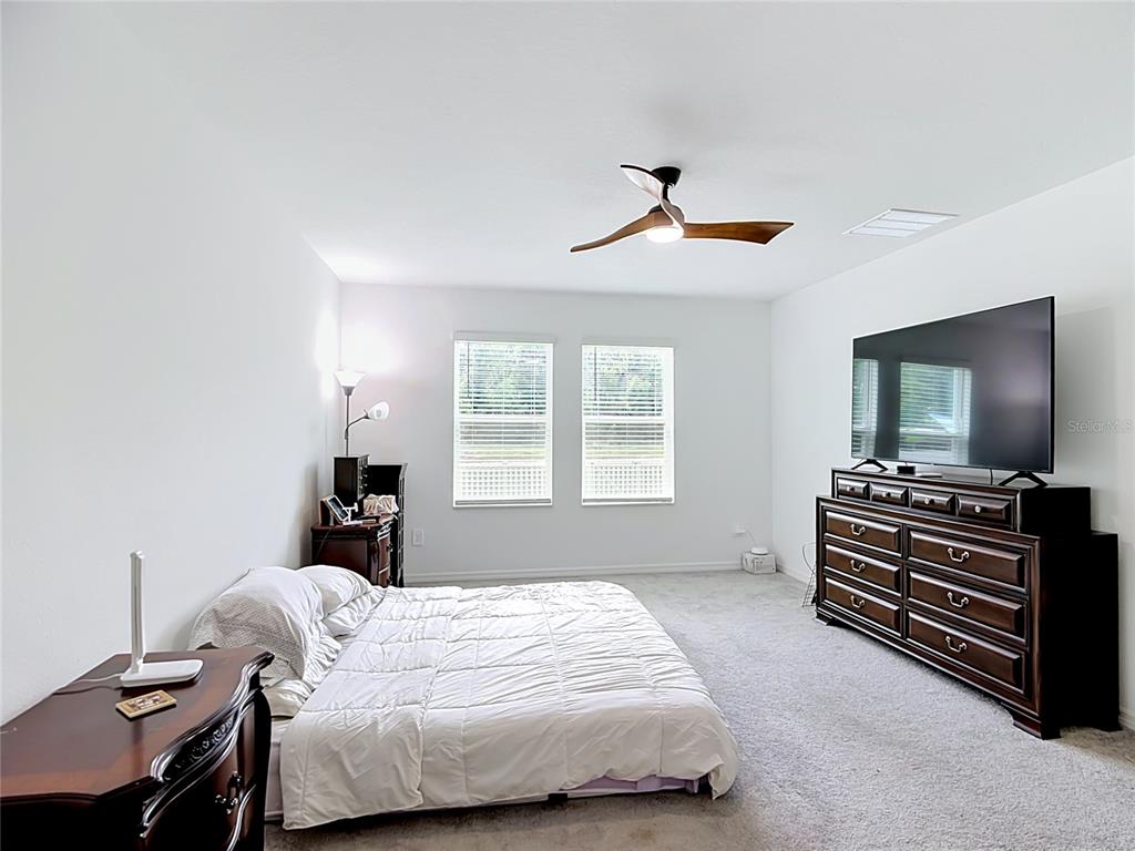1633 Red Loop Lakeland, FL 33801 - Photo 25 of 60 a bedroom with a bed and a flat screen tv