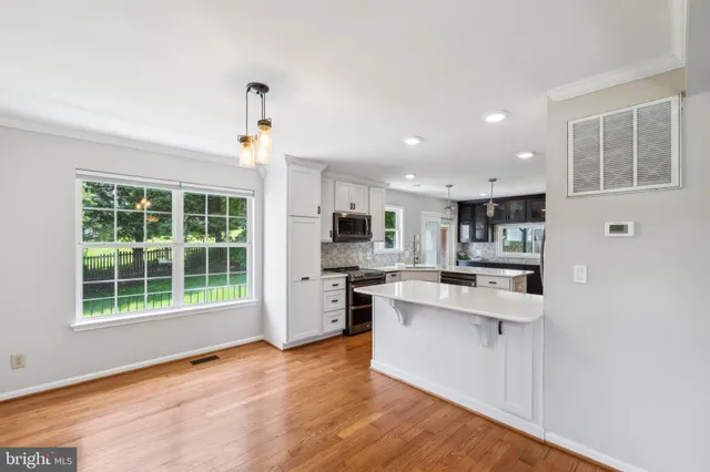 a kitchen with stainless steel appliances granite countertop a stove and a refrigerator