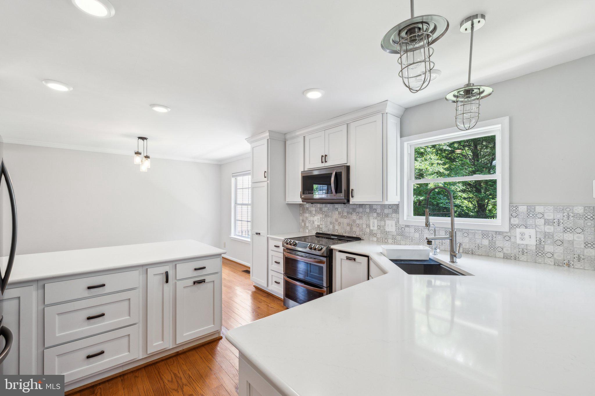 14 St Peters Court Stafford, VA 22556 - Photo 17 of 47 a kitchen with stainless steel appliances kitchen island granite countertop a sink window and cabinets