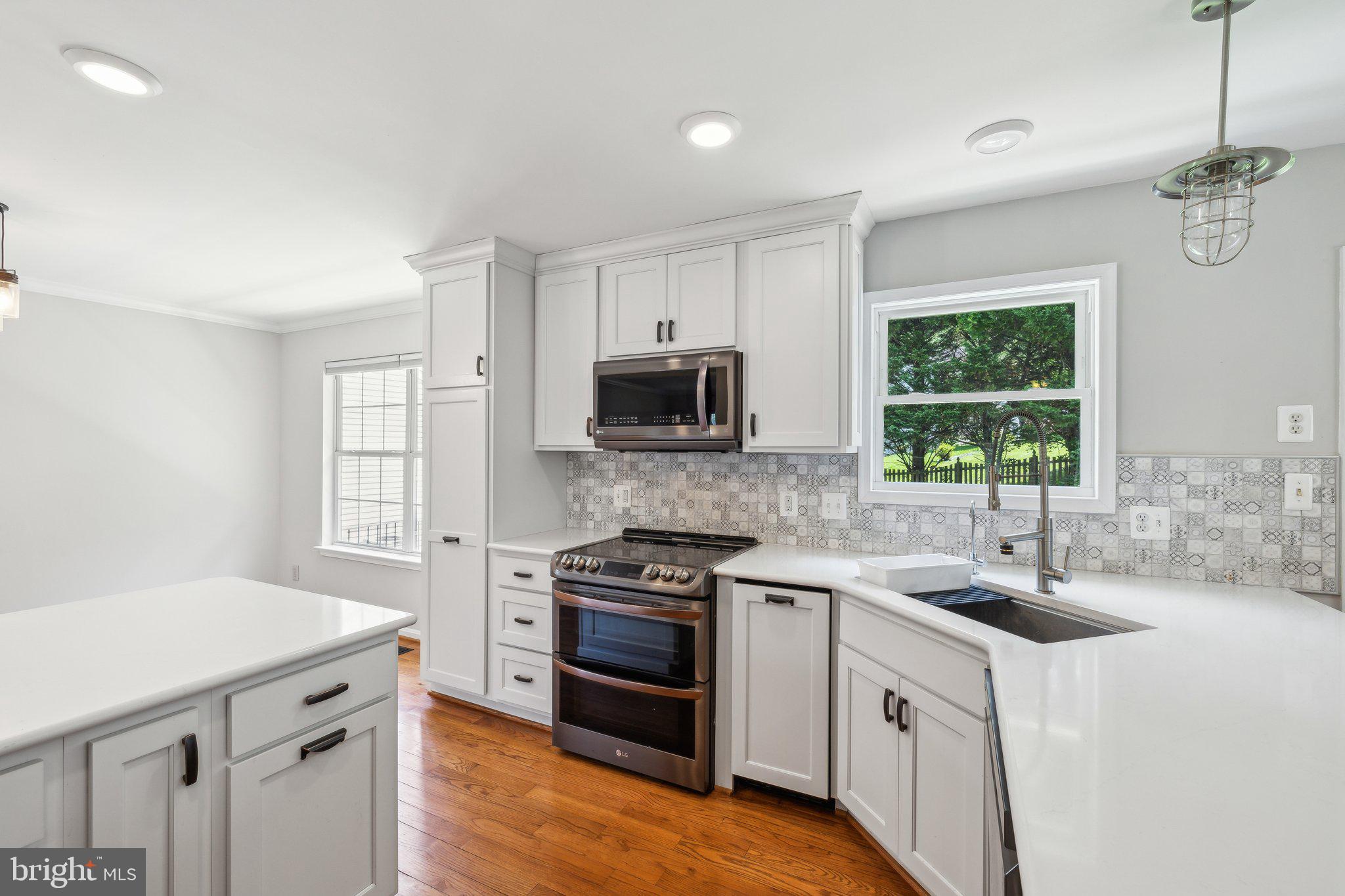 14 St Peters Court Stafford, VA 22556 - Photo 19 of 47 a kitchen with a sink stove and microwave