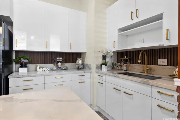 a kitchen with granite countertop white cabinets and white appliances