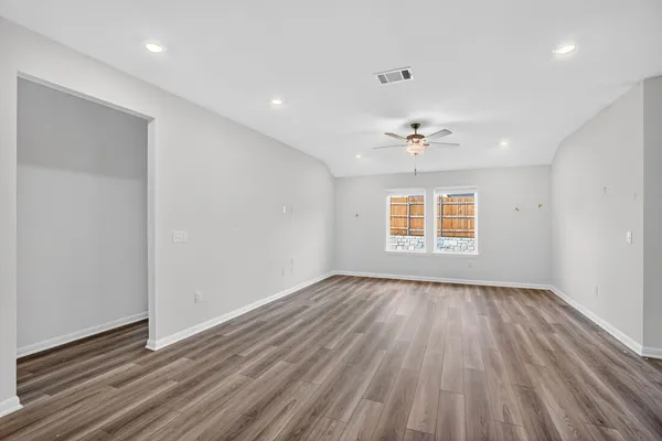 wooden floor in an empty room with a window