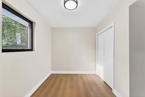 a view of a room with wooden floor and windows