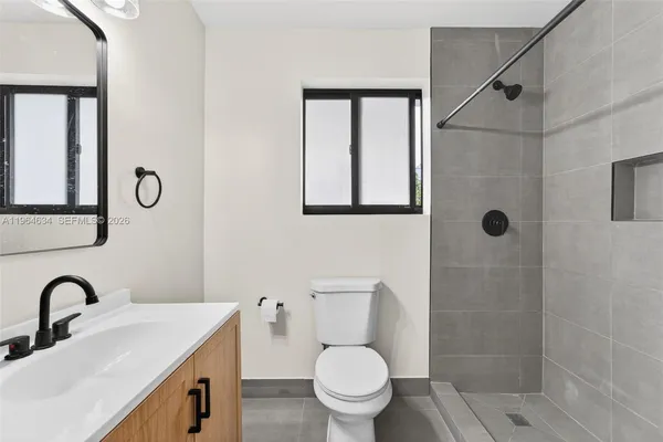 a bathroom with a sink a toilet and a shower