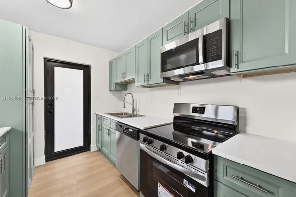 a kitchen with a stove and a microwave