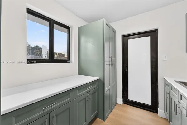 a room with a sink and a mirror