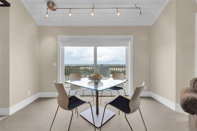 a view of a dining room with furniture window and outside view