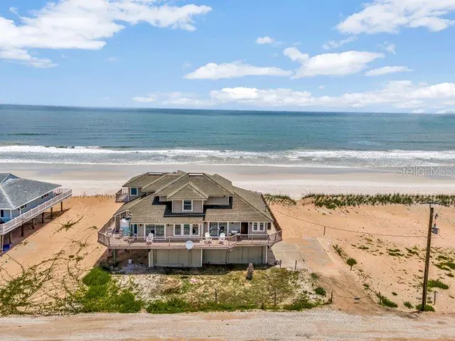 a view of a ocean with a table and chairs