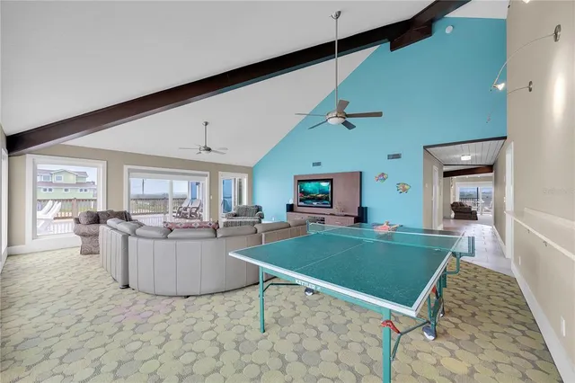 a spacious bedroom with a bed and a tv