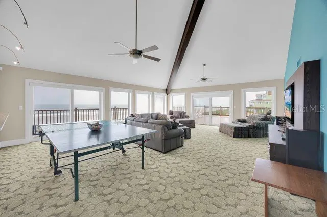 a spacious bedroom with a bed a dresser and next to a window