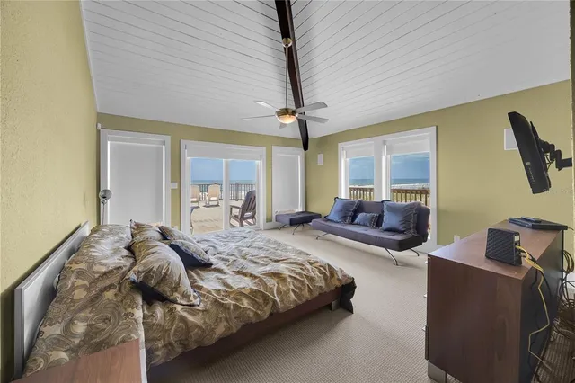 a view of a hallway with a livingroom and a bathroom