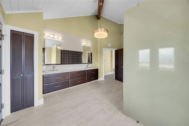 a view of a house next to a yard with large trees